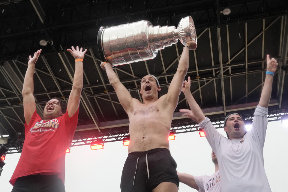 Florida Panthers' Nick Cousins, center, raises the Stanley Cup during an NHL hockey parade and rally, Sunday, June 30, 2024, in Fort Lauderdale, Fla. The Panthers defeated the Edmonton Oilers to win the cup. (AP Photo/Marta Lavandier)