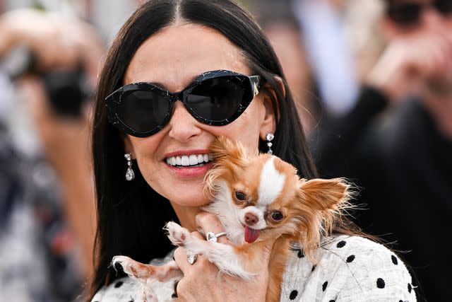 <p>Stephane Cardinale - Corbis/Corbis via Getty</p> Demi Moore and Pilaf the dog