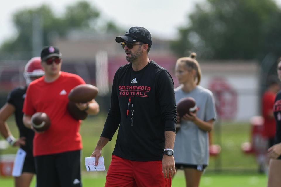 USD Offensive Coordinator Josh Davis coaching players during football practice at University of South Dakota in Vermillion , South Dakota on Wednesday, August 9, 2023.