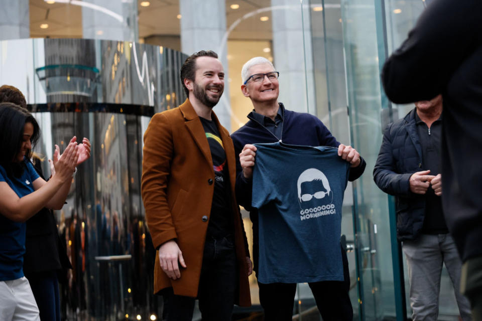 Apple CEO Tim Cook greets people as they enter the Fifth Avenue Apple store Feb. 2, 2024, in New York City.