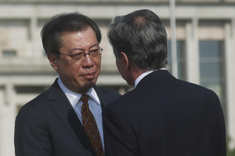 U.S. Secretary of State Antony Blinken, right, is welcomed by Yang Tao, Director General of the Department of North American and Oceanian Affairs of the Foreign Ministry, as he arrives in Beijing, Sunday, June 18, 2023. (Leah Millis/Pool Photo via AP)