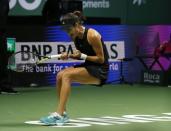 Ana Ivanovic of Serbia celebrates her win over Eugenie Bouchard of Canada during their WTA Finals singles tennis match at the Singapore Indoor Stadium October 22, 2014. REUTERS/Edgar Su