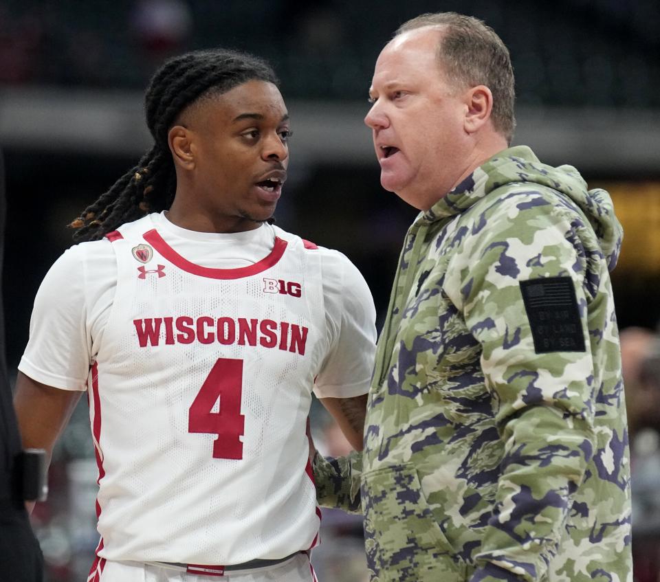 Wisconsin head coach Greg Gard talks with guard Kamari McGee during the first half of their game against Stanford last Friday.