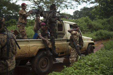 Former Seleka soldiers prepare to drive to a village, where residents say was attacked and a mosque burnt the night before by anti-Balaka militiamen, about 25 kilometres (16 miles) from Bambari May 10, 2014. REUTERS/Siegfried Modola