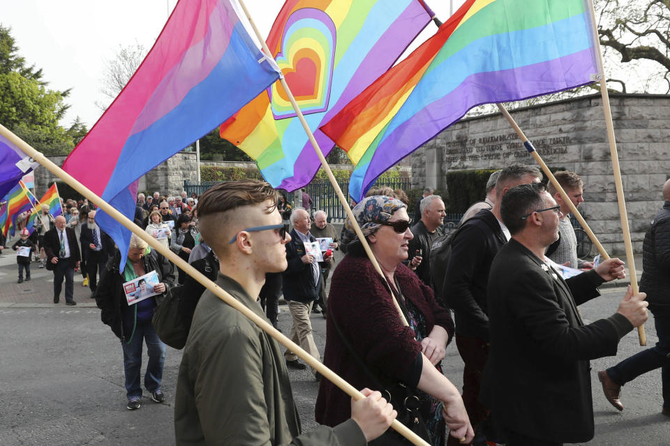 People walk during a vigil for murdered journalist 29 year-old Lyra McKee, in Dublin, Ireland, Tuesday April 23, 2019. McKee was shot dead April 18, while reporting on rioting in Londonderry, Northern Ireland, and an Irish Republican Army (IRA) splinter group has admitted responsibility and apologised for the killing. (Niall Carson/PA via AP)