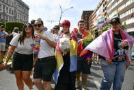 People taking part in a gay pride parade pose before the start of the event in Budapest, Hungary, Saturday, July 24, 2021. Hungary's government led by right-wing Prime Minister Viktor Orban passed a law in June prohibiting the display of content depicting homosexuality or gender reassignment to minors, a move that has ignited intense opposition in Hungary while EU lawmakers have urged the European Commission to take swift action against Hungary unless it changes tack. (AP Photo/Anna Szilagyi)