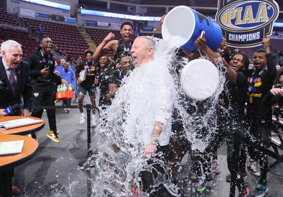The Lincoln Park Leopards shower head coach Mike Bariski with water after the Leopards defeated Neumann Goretti 62-58 in the PIAA 4A Championship game Thursday night at the Giant Center in Hershey, PA.