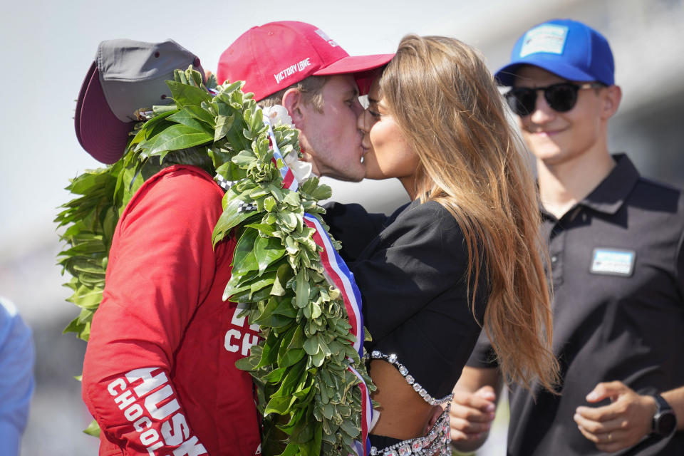 Marcus Ericsson, left, of Sweden, kisses girlfriend Iris Tritsaris Jondahl after winning the Indianapolis 500 auto race at Indianapolis Motor Speedway in Indianapolis, Sunday, May 29, 2022. (AP Photo/AJ Mast)