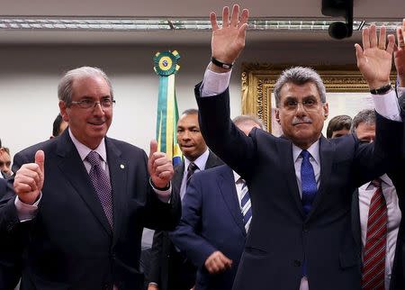 Senator Romero Juca (R) and Lower House Speaker Eduardo Cunha of the Brazilian Democratic Movement Party (PMDB) celebrate after announcing that they are withdrawing their support of President Dilma Rousseff's ruling coalition during their National Executive Meeting in Brasilia, Brazil, March 29, 2016. REUTERS/Adriano Machado