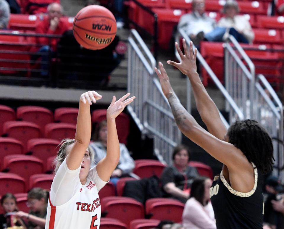 Texas Tech's guard Rhyle McKinney (5) shoots a three-point shot against Colorado in a preseason WNIT game, Wednesday, Nov. 16, 2022, at United Supermarkets Arena. 