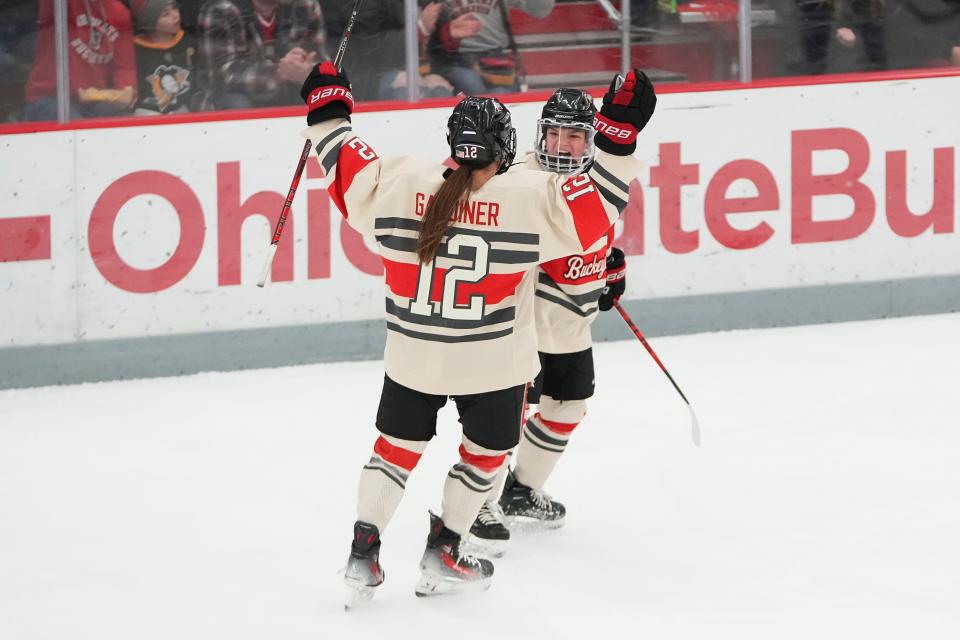 Feb 17, 2024; Columbus, Ohio, USA; Ohio State forward Jennifer Gardiner (12) celebrates a goal by defenseman Cayla Barnes (23) during the NCAA women’s ice hockey game against St. Thomas at the Ohio State Ice Rink.