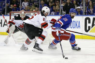 New York Rangers left wing Chris Kreider (20) controls the puck in front of New Jersey Devils defenseman John Marino during the first period of Game 3 of the team's NHL hockey Stanley Cup first-round playoff series Saturday, April 22, 2023, in New York. (AP Photo/Adam Hunger)