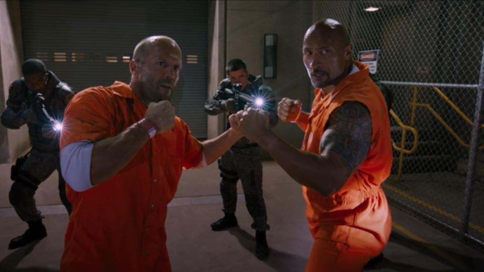 Jason Statham and Dwayne Johnson putting their fists up