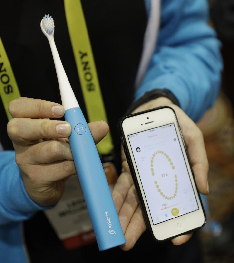 An employee holds up the Ara smart tooth brush at the Kolibree booth during CES Unveiled before CES International, Tuesday, Jan. 3, 2017, in Las Vegas. A processor in the brush records brushing behaviors and through and app can give advice. (AP Photo/John Locher)