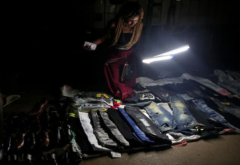 Clothes and shoes are displayed for sale at a roadside night market in central Harare