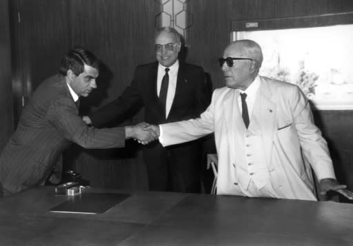 In this file photo taken on New Year's day 1986, former Tunisian President Habib Ben Ali Bourguiba (R) shakes hands with his then prime minister Zine El-Abidine Ben Ali, who went on to replace him the following year