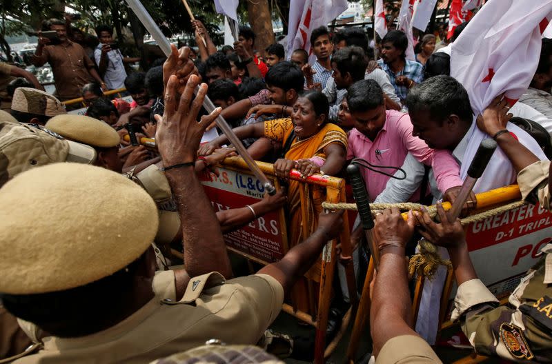 Police officers stop demonstrators during a protest against a new citizenship law, in Chennai