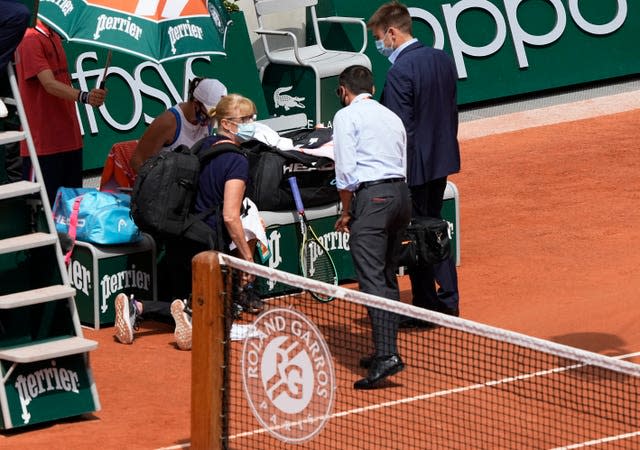 Ashleigh Barty talks to medical personnel at the end of the first set