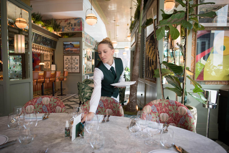 Staff at the Ivy Victoria in London, prepare the dining area, as the government initiative Eat Out to Help Out comes to an end. (Photo by Stefan Rousseau/PA Images via Getty Images)