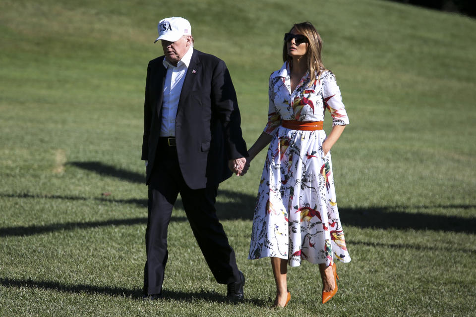 Crossing the South Lawn of the White House residence after spending the weekend away, Melania Trump wore a cotton printed midi-dress from Kasia retailing for £970. [Photo: Getty]