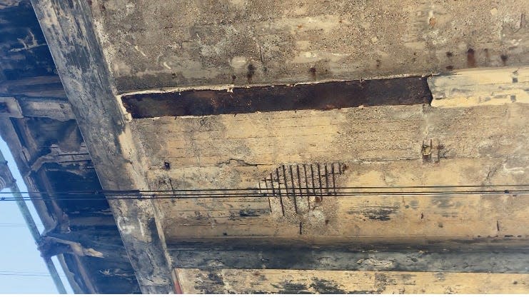 Concrete-encased iron beam and reinforcing bars are laid bare from deteriorating conditions beneath the Edgely bridge in Bristol Township. The bridge was built in 1919 and carries traffic over the busiest rail lines in the nation, the Northeast Corridor.