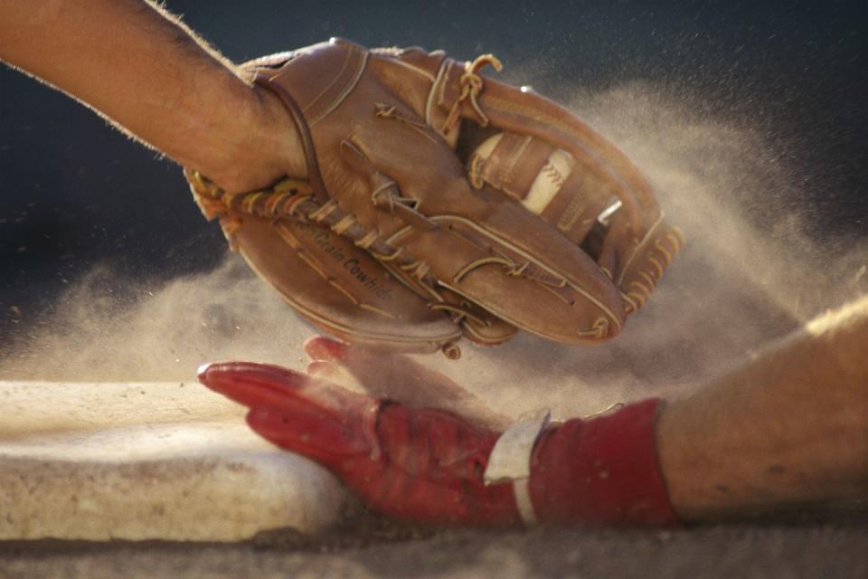 baseball player sliding into base, baseman tagging player, close up