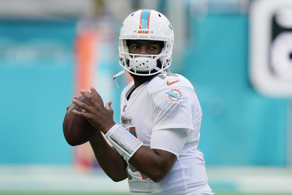 FILE -Miami Dolphins quarterback Jacoby Brissett (14) warms up before an NFL football game against the New York Giants, Sunday, Dec. 5, 2021, in Miami Gardens, Fla. While they wait to welcome Deshaun Watson, the Browns have traded backup quarterback Case Keenum to Buffalo and signed free agent QB Jacoby Brissett, a person familiar with the deal told The Associated Press on Saturday, March 19, 2022. (AP Photo/Wilfredo Lee, File)