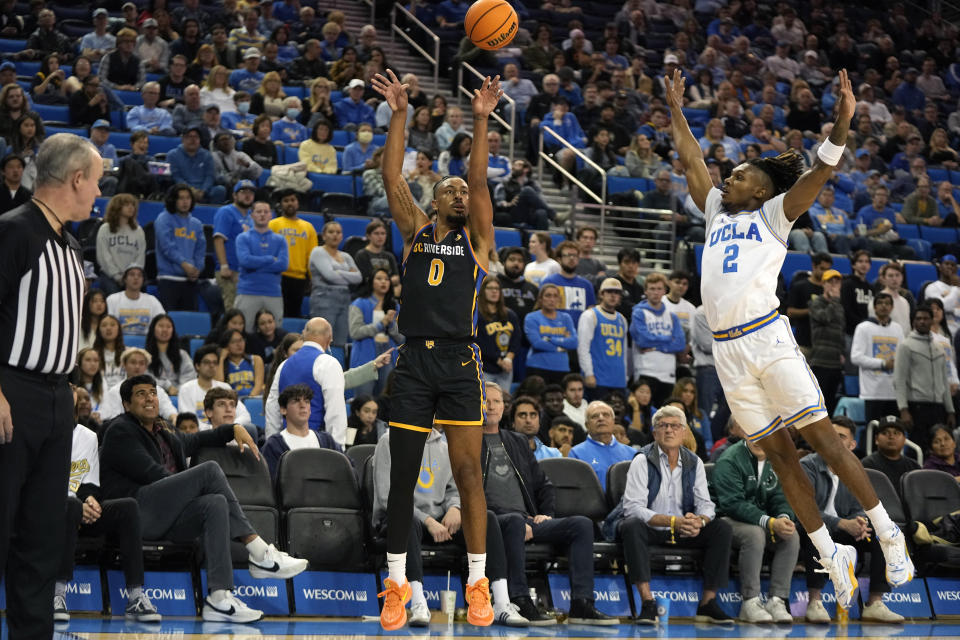 UC Riverside forward Kyle Owens, center, shoots as UCLA guard Dylan Andrews defends during the first half of an NCAA college basketball game Thursday, Nov. 30, 2023, in Los Angeles. (AP Photo/Mark J. Terrill)