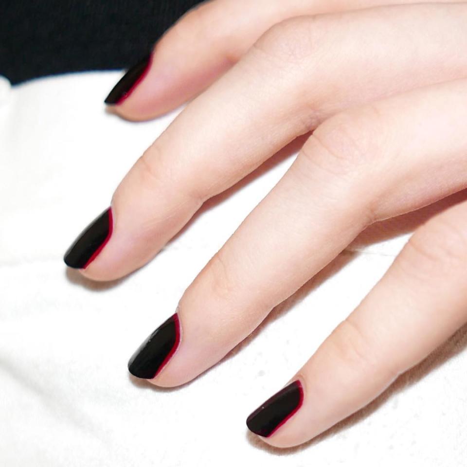 Start with a bright red base and layer a dark burgundy shade on top so just a sliver of red peeks out at the cuticle. (Need recs? <a href="https://www.glamour.com/gallery/best-dark-red-nail-polishes?mbid=synd_yahoo_rss" rel="nofollow noopener" target="_blank" data-ylk="slk:We've got tons;elm:context_link;itc:0;sec:content-canvas" class="link ">We've got tons</a>.)