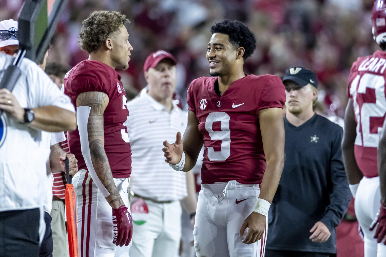Alabama quarterback Bryce Young (9) talks with wide receiver Jermaine Burton (3) during the second half of an NCAA college football game against Vanderbilt, Saturday, Sept. 24, 2022, in Tuscaloosa, Ala. (AP Photo/Vasha Hunt)