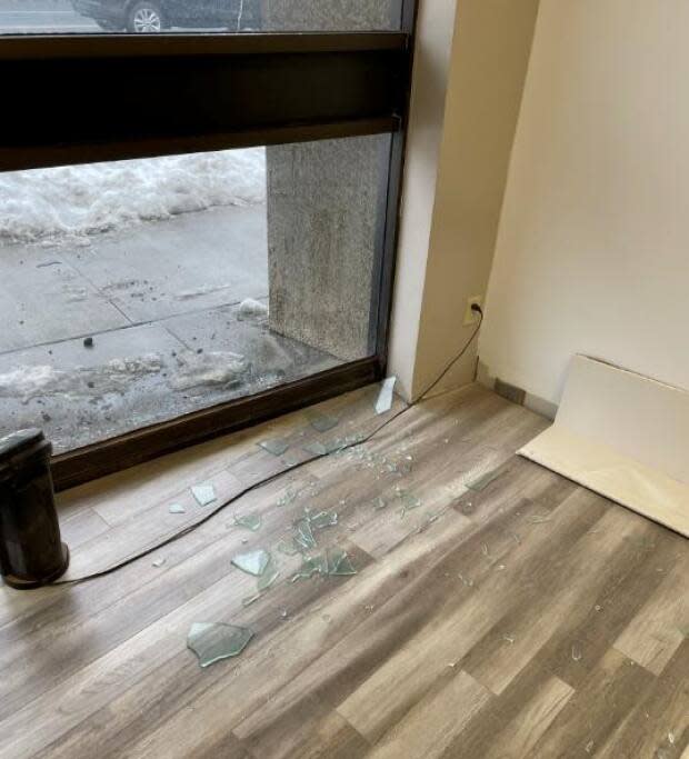 Executive director of WE Trans Support, Alexander Reid, says he arrived to the office to in February to find the window had been broken.  (Submitted by Alexander Reid  - image credit)
