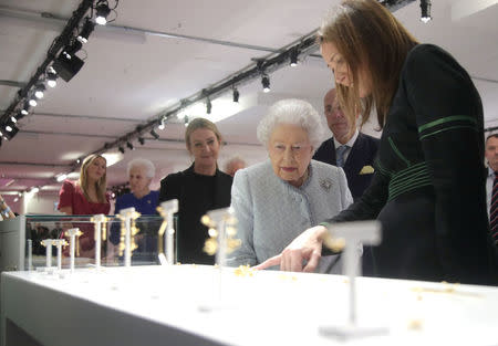 Britain's Queen Elizabeth II stands next to Caroline Rush, Chief Executive of the British Fashion Council (BFC), as she is given a tour of the London Fashion Week showrooms during her visit at London Fashion Week, in London, Britain February 20, 2018. REUTERS/Yui Mok/Pool