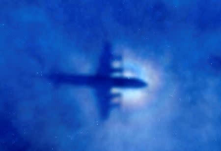 The shadow of a Royal New Zealand Air Force (RNZAF) P3 Orion maritime search aircraft can be seen on low-level clouds as it flies over the southern Indian Ocean looking for missing Malaysian Airlines flight MH370 March 31, 2014. REUTERS/Rob Griffith/Pool/Files