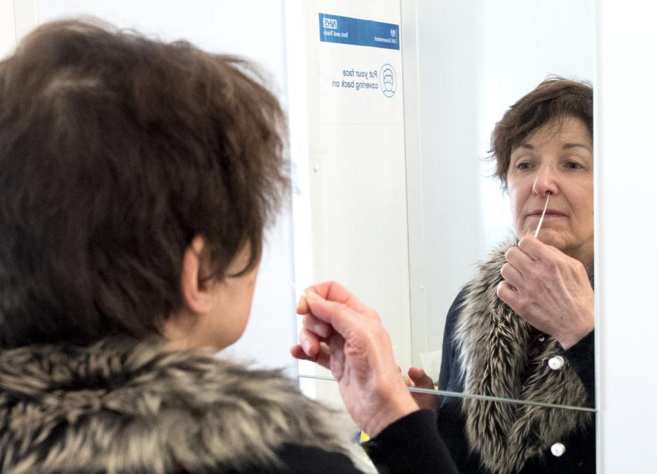 A woman takes a lateral flow test for Covid (Stock image)  (PA Wire)