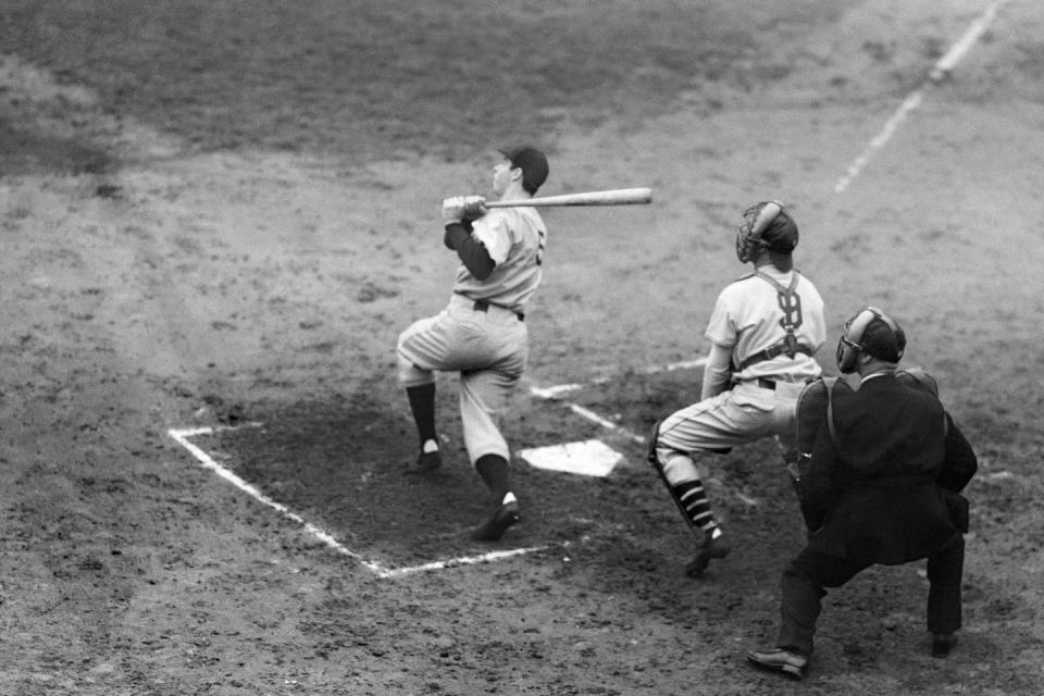 New York Yankees’ Joe DiMaggio hits a solo home run in Game 5 of the World Series at the Polo Grounds in New York in October 1937. Cooper embraced less traditionally newsworthy subjects, like sports, during his tenure. (AP Photo)