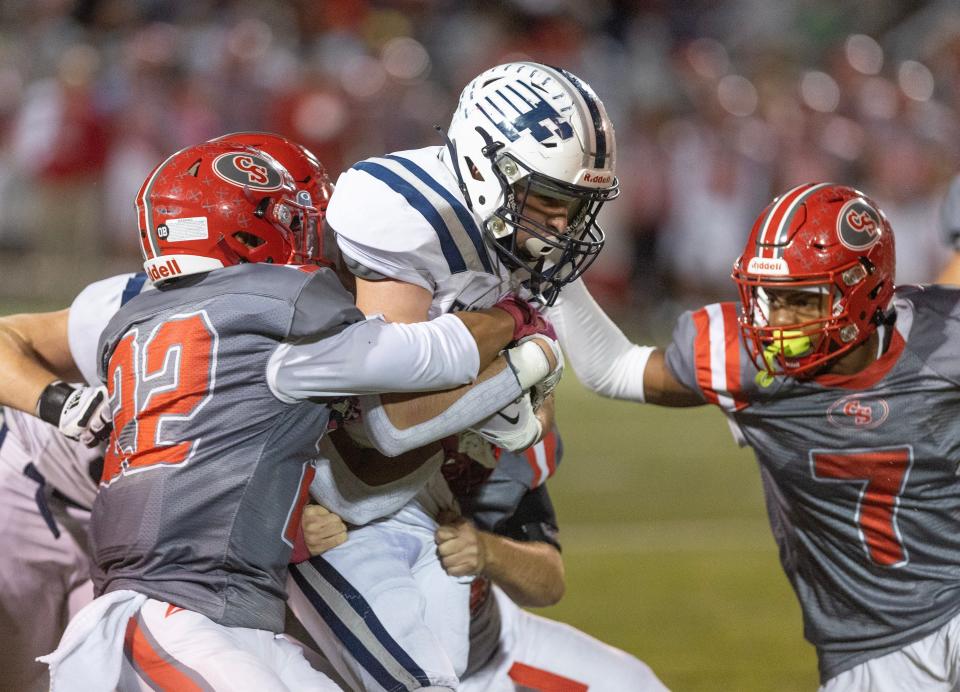 Fairless' Gio Moore fights for yardage as Canton South's Tre Wilson (22) and Lance Long (7) work to bring him down during last week's game.