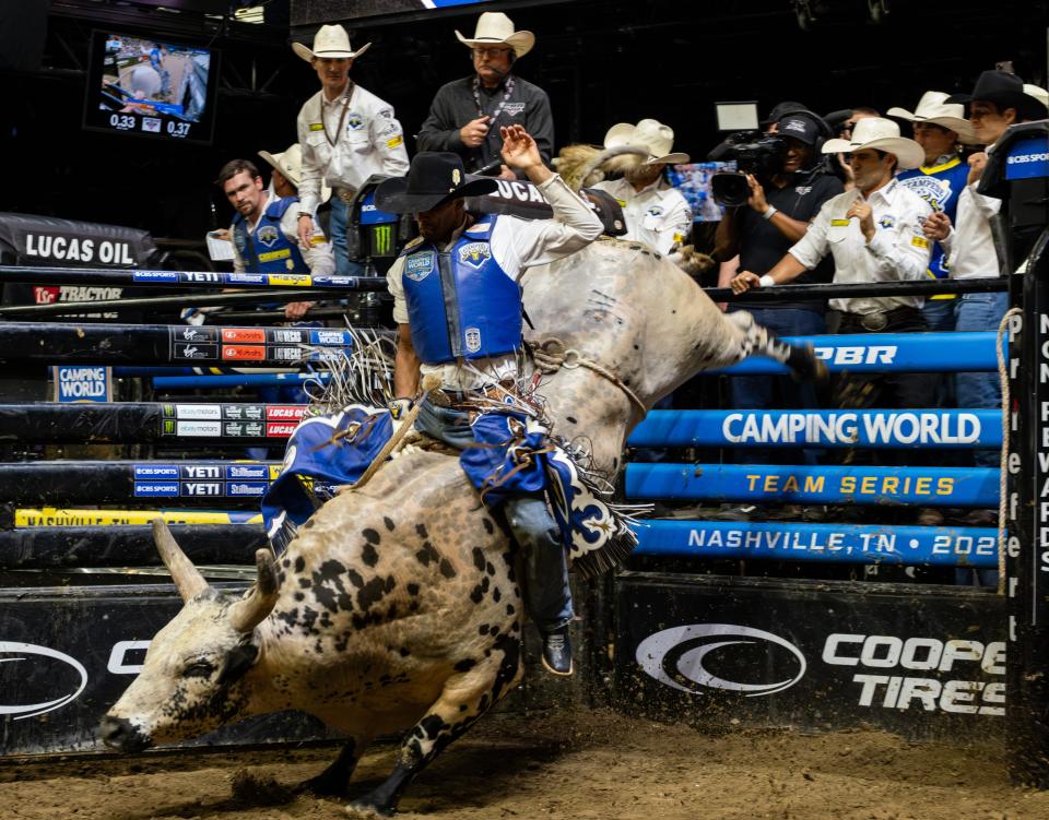 A bull rider for the Nashville Stampede holds onto his bull during the second night of the PBR Camping World Team Series Stampede Days at Bridgestone Arena in Nashville, Tenn., on Aug. 19.