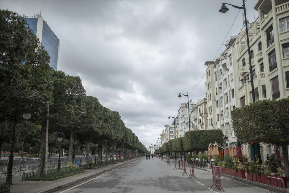 Tunis' landmark Avenue Habib Bourgiba, where massive protests took place in 2011, is empty on the tenth anniversary of the uprising, due to a national lockdown after a surge in COVID-19 cases, in Tunis, Thursday, Jan. 14, 2021. Tunisia is commemorating the 10th anniversary since the flight into exile of its iron-fisted leader, Zine El Abidine Ben Ali, pushed from power in a popular revolt that foreshadowed the so-called Arab Spring. But there will be no festive celebrations Thursday marking the revolution in this North African nation, ordered into lockdown to contain the coronavirus. (AP Photo/Mosa'ab Elshamy)