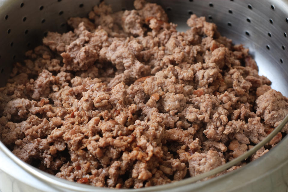 ground beef draining on a collander