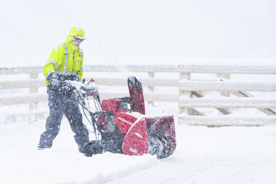 Snow is cleared on the Big Mountain Resort property during a storm, Saturday, March 30, 2024, in Big Bear Lake, Calif. (Big Mountain Resort via AP)