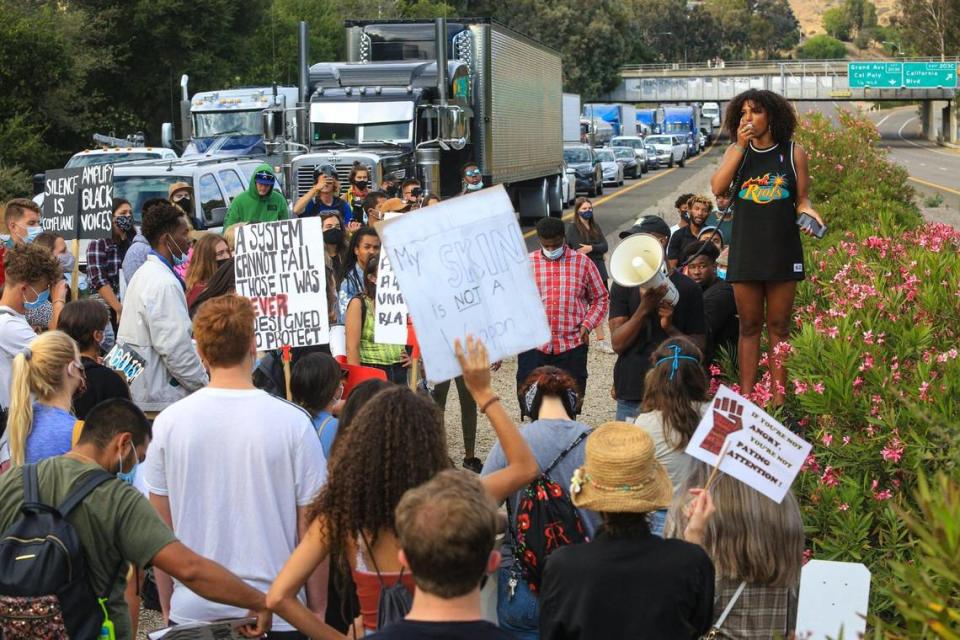 Protest organizer Tianna Arata speaks to marchers after they closed traffic on Highway 101 in San Luis Obispo during the No Justice No Peace demonstration on July 21, 2020. Arata was later arrested for her role in the protest and charged with 13 misdemeanors.