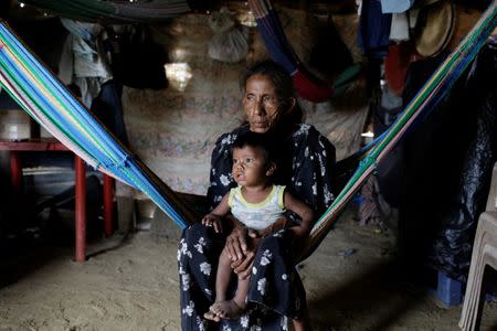 Elvira Urdaneta (58) holds her grandchild Josue Urdaneta (2) at her hovel in Paraguaipoa, Venezuela March 1, 2017. REUTERS/Marco Bello