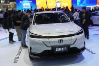 Visitors look at Honda's electric vehicle "E:N1" during the 45th Bangkok Motor Show in Nonthaburi, Tuesday, March 26, 2024. Thailand. (AP Photo/Sakchai Lalit)