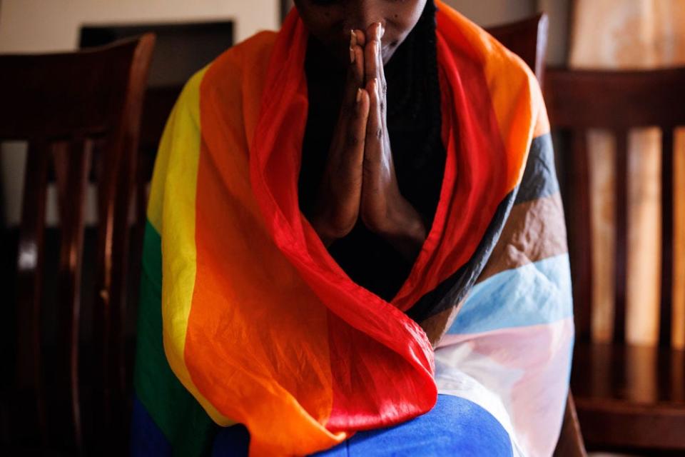 A member of the LGBTQ community prays during an evangelical church service on April 23, 2023 in Kampala, Uganda