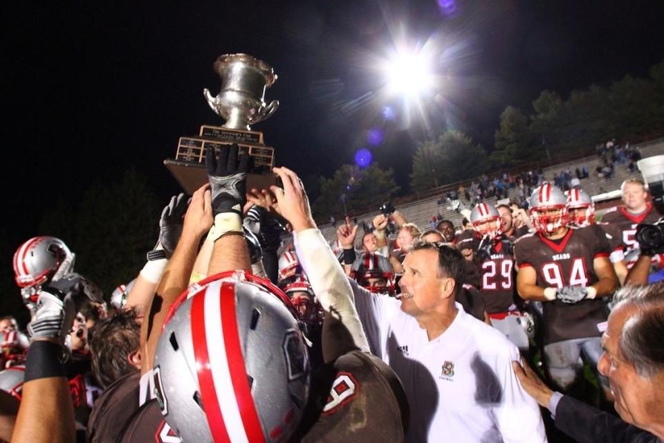 Brown coach Phil Estes and the Brown Bears hoist the Governor's Cup after beating URI back in 2013.
