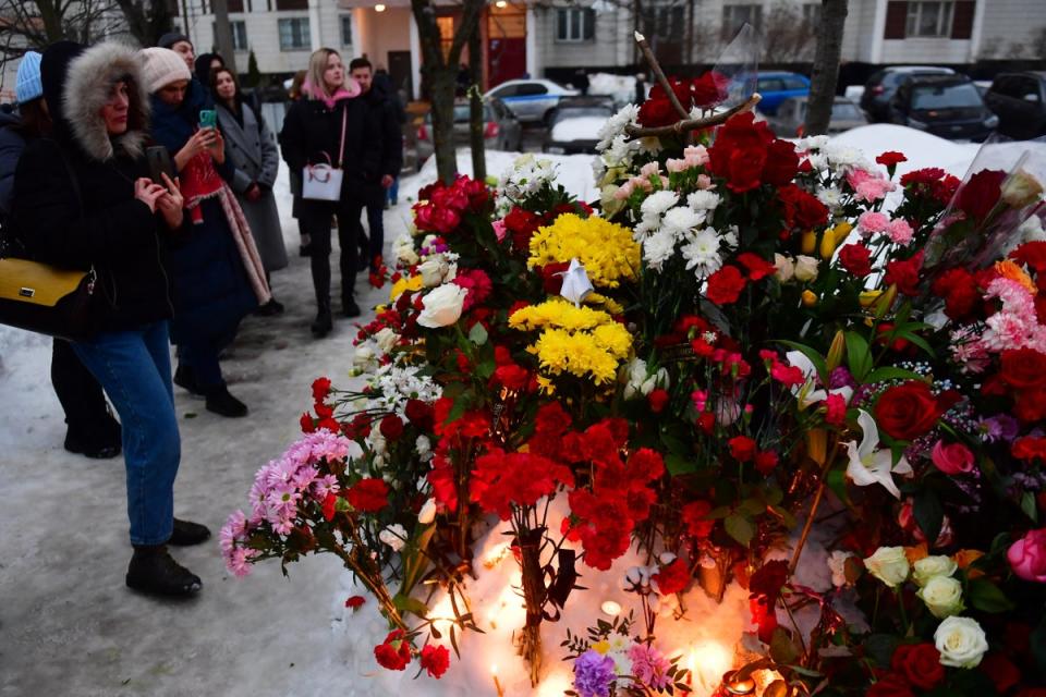 Tributes at a makeshift memorial outside the cemetery (AFP)