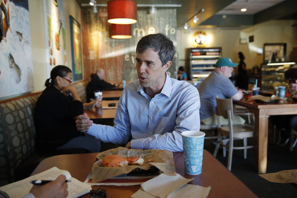 Democratic presidential candidate and former Texas congressman Beto O'Rourke speaks with a reporter while eating lunch at a restaurant Sunday, March 24, 2019, in Las Vegas. (AP Photo/John Locher)
