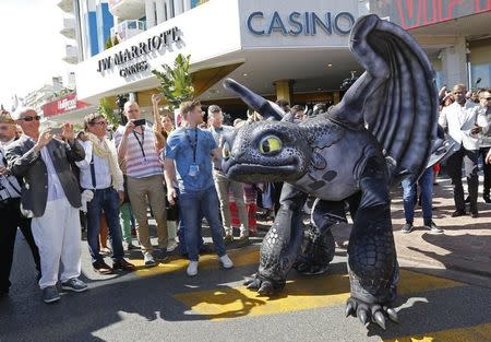 A figure of Toothless the Dragon character walks on the Croisette during a photocall for the film "How to Train Your Dragon 2" at the 67th Cannes Film Festival in Cannes May 15, 2014. REUTERS/Yves Herman