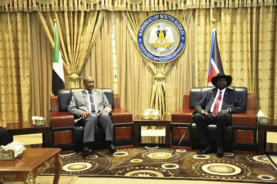 In this photo provided by the official SUNA news agency, Gen. Abdel-Fattah Burhan, left, head of Sudan’s sovereign council, meets with South Sudan’s President Salva Kiir, in Juba, South Sudan, Monday, Oct. 14, 2019. Sudan's new transitional government is starting talks Monday with rebel leaders in South Sudan's capital, Juba to kick off peace talks aimed at ending the country's yearslong civil wars. Achieving peace is crucial to the transitional government in Sudan. It has counted on ending the wars with rebels in order to revive the country's battered economy through slashing the military spending, which takes up much of the national budget. (SUNA via AP)