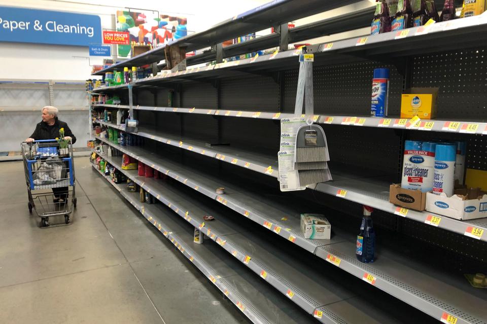 Shelves are nearly empty at a Walmart in Warrington, Pennsylvania, on March 17. Walmart has said it will provide up to two weeks' pay for employees who test positive for COVID-19. (ASSOCIATED PRESS)